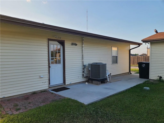 rear view of house featuring a patio, central AC unit, and fence