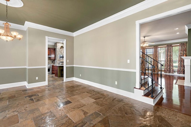 unfurnished room featuring dark hardwood / wood-style flooring, ceiling fan with notable chandelier, and ornamental molding