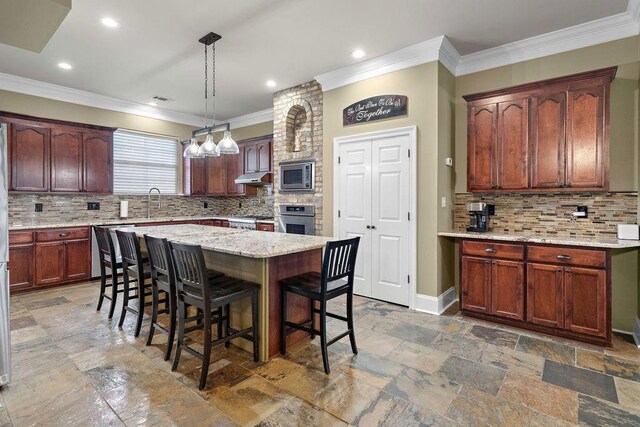 kitchen with backsplash, stainless steel appliances, and decorative light fixtures