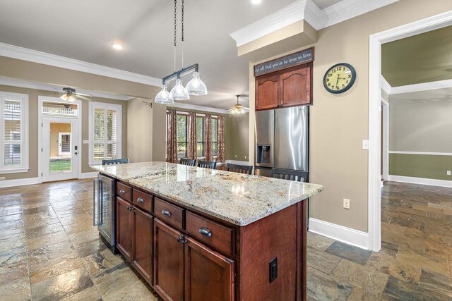 kitchen with a center island, ceiling fan, tile patterned floors, and stainless steel refrigerator with ice dispenser