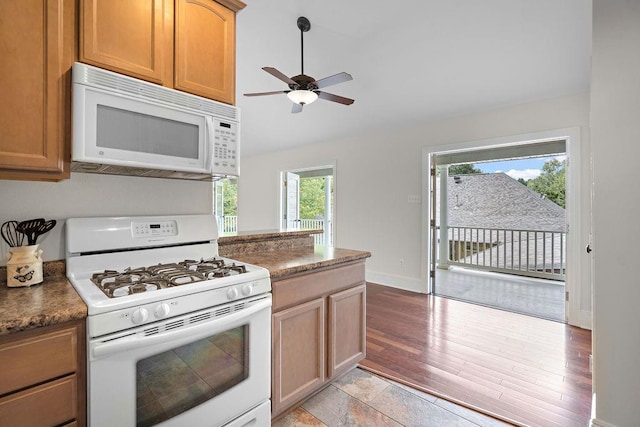 kitchen featuring ceiling fan, light hardwood / wood-style floors, and white appliances