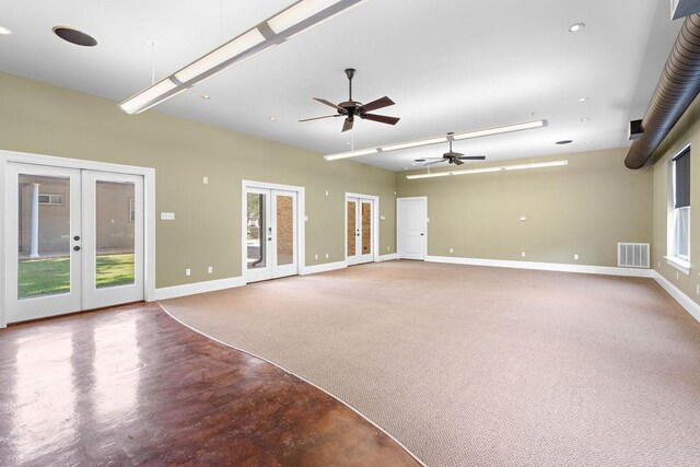 empty room featuring ceiling fan, plenty of natural light, and french doors