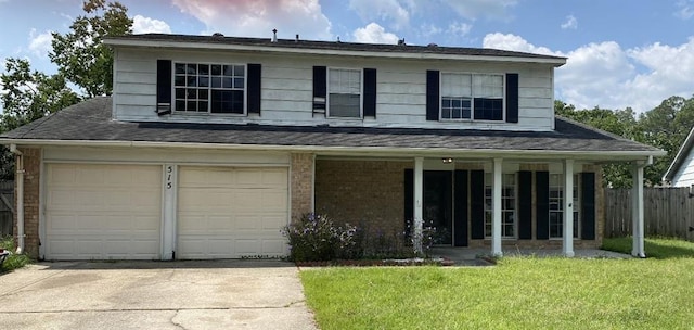 view of front facade with a front yard and a garage