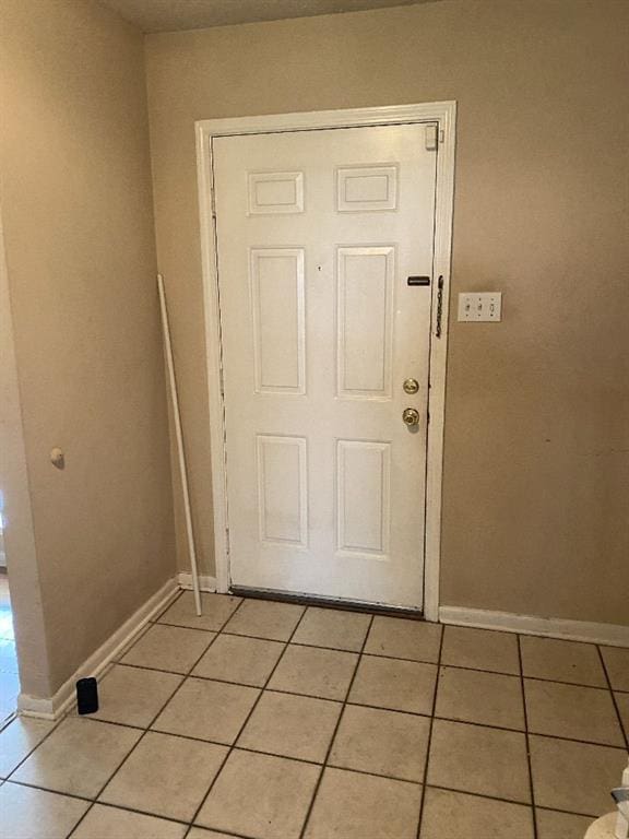 doorway with light tile patterned floors