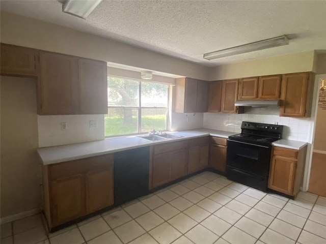 kitchen with backsplash, sink, dishwashing machine, light tile patterned floors, and black electric range oven