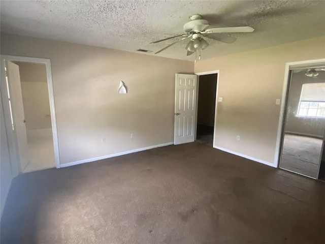 unfurnished bedroom featuring ceiling fan, carpet, and a textured ceiling