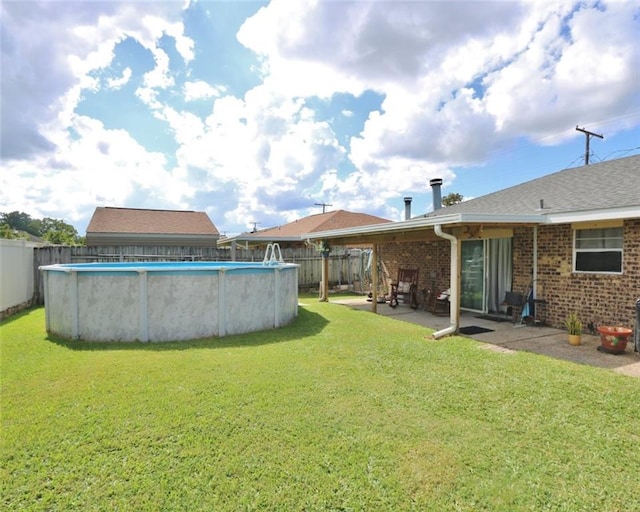 view of yard featuring a fenced in pool and a patio area