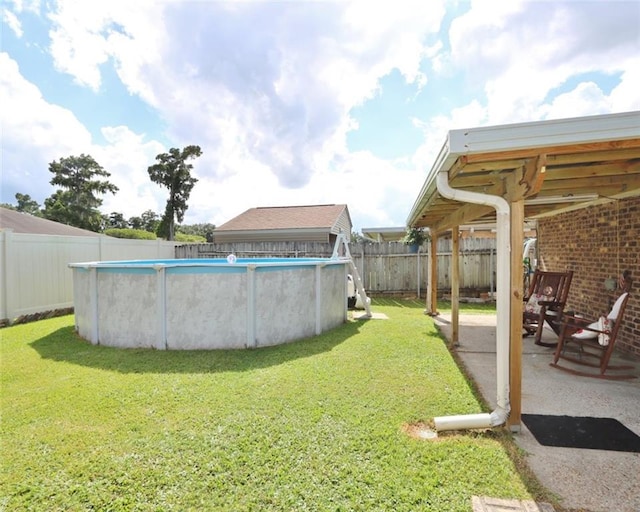 view of yard with a fenced in pool