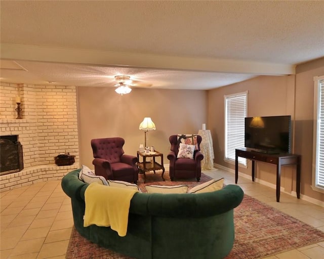 tiled living room featuring a textured ceiling and a fireplace