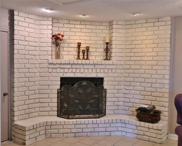 details with tile patterned floors, a fireplace, and a textured ceiling