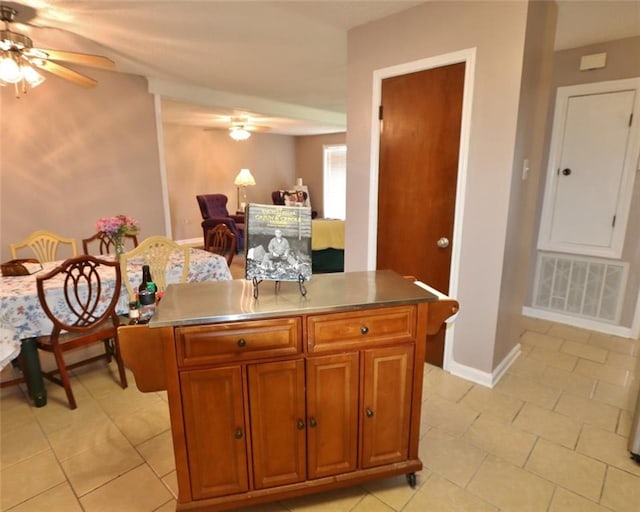 kitchen with ceiling fan and light tile patterned floors