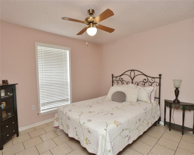 bedroom with ceiling fan, multiple windows, and light tile patterned floors