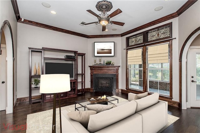 living room with dark hardwood / wood-style flooring, a wealth of natural light, and ornamental molding