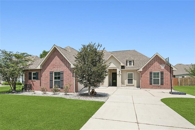 view of front of home featuring a garage and a front lawn