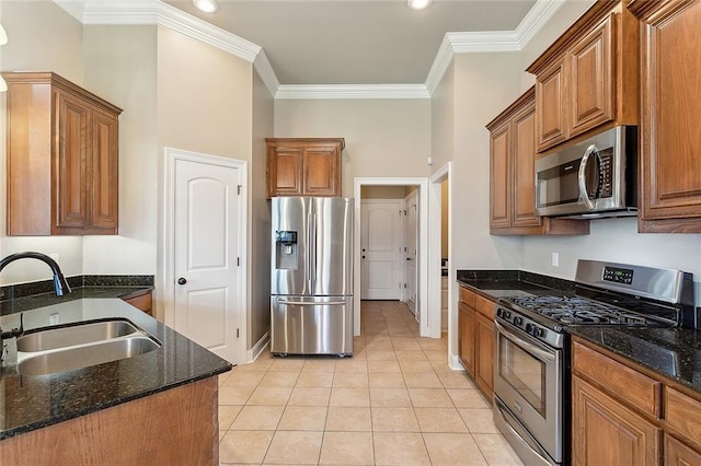 kitchen featuring light tile patterned flooring, sink, dark stone countertops, appliances with stainless steel finishes, and crown molding