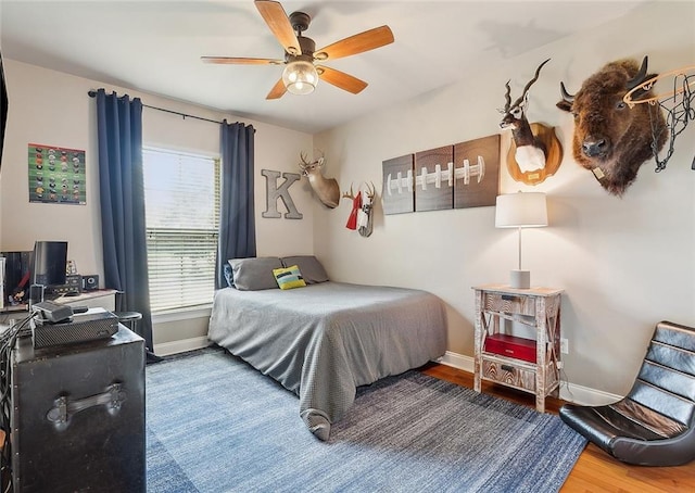 bedroom with ceiling fan and hardwood / wood-style flooring