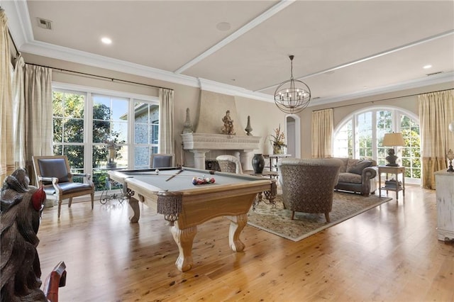 rec room featuring ornamental molding, visible vents, a fireplace, and light wood-style flooring