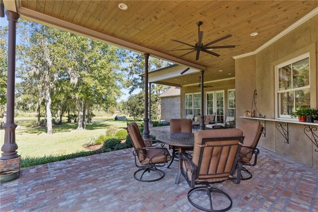 sunroom / solarium featuring wood ceiling and ceiling fan