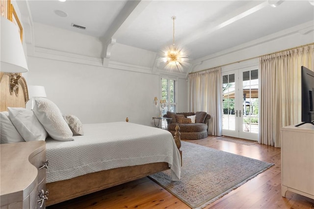 bedroom featuring french doors, multiple windows, visible vents, and access to exterior