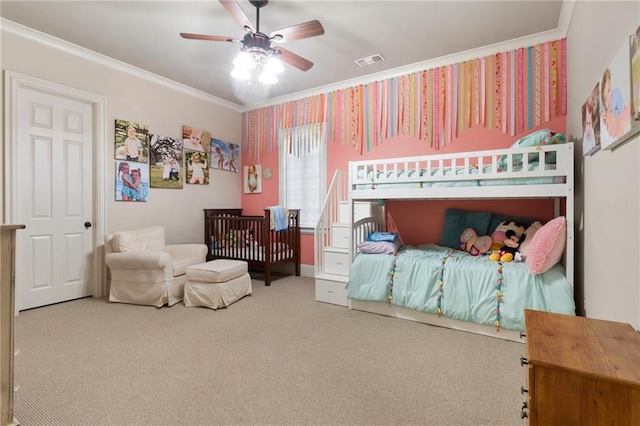 bedroom featuring ceiling fan, carpet floors, ornamental molding, and visible vents