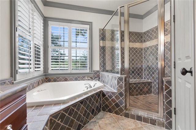 bathroom featuring a wealth of natural light, a stall shower, a garden tub, and vanity