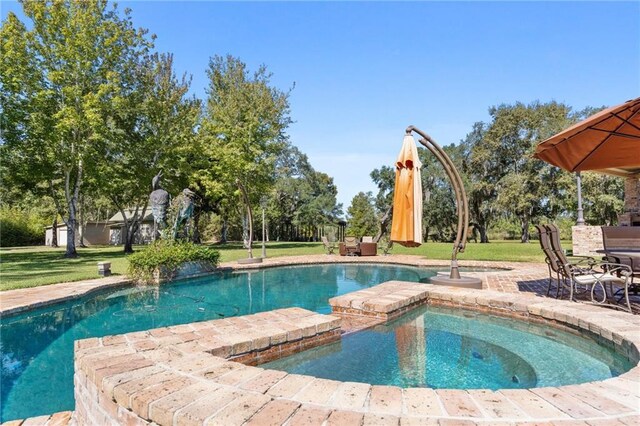 view of swimming pool with an in ground hot tub and a lawn