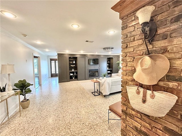 living room with a fireplace and ornamental molding