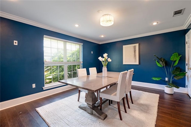 dining room featuring dark hardwood / wood-style floors, a wealth of natural light, and ornamental molding