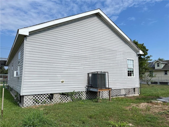 view of home's exterior featuring a yard, crawl space, and fence