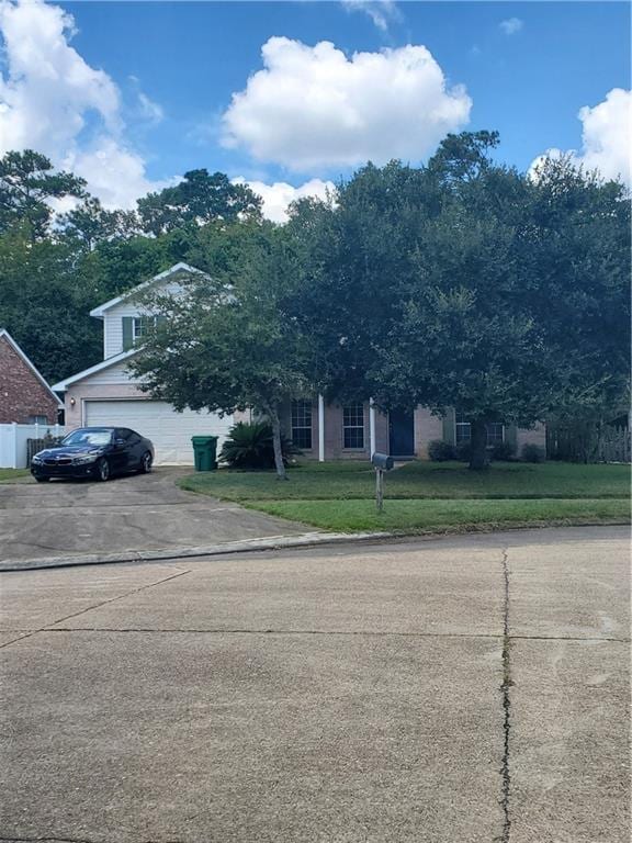 view of front of property with a garage and a front lawn