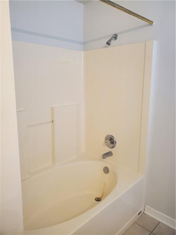 bathroom with washtub / shower combination and tile patterned floors