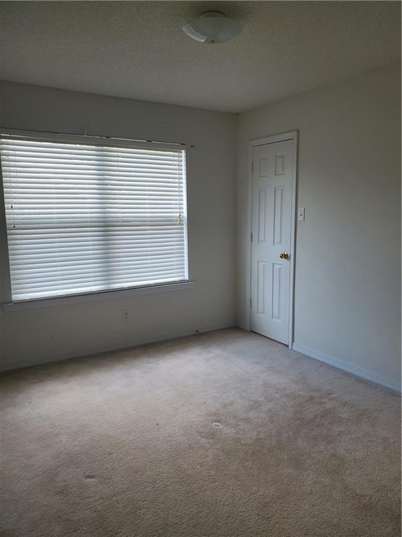 1122 Lori Dr, Slidell, LA 70461 - spare room featuring light colored carpet and baseboards