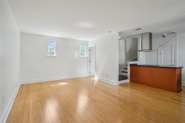 unfurnished living room with light hardwood / wood-style flooring