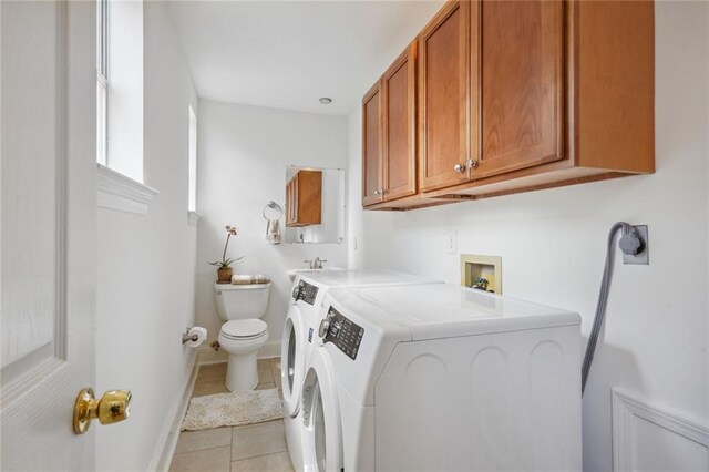 washroom with independent washer and dryer and light tile patterned flooring