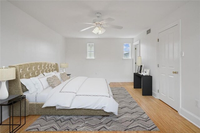 bedroom with light hardwood / wood-style floors and ceiling fan