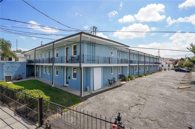 view of property exterior featuring a balcony and cooling unit