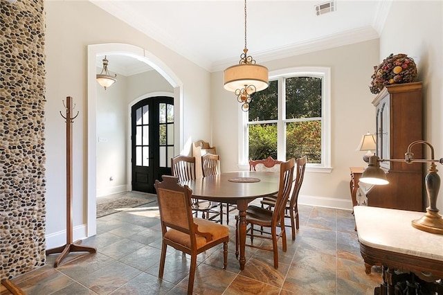 dining space featuring crown molding and french doors