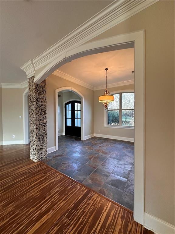 foyer entrance featuring dark hardwood / wood-style floors, ornamental molding, and french doors