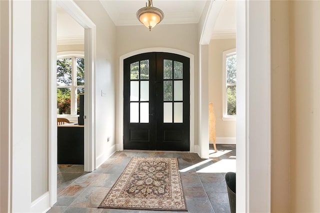 foyer entrance with french doors and ornamental molding