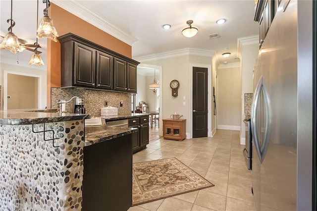 kitchen with stainless steel appliances, crown molding, pendant lighting, and light tile patterned flooring