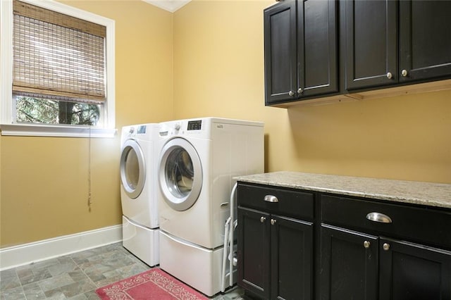 washroom with independent washer and dryer and cabinets