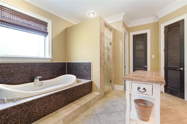 bathroom featuring independent shower and bath, ornamental molding, and tile patterned floors