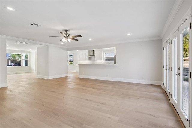 unfurnished living room with ornamental molding, french doors, ceiling fan, and light hardwood / wood-style floors