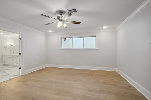 empty room featuring crown molding, light hardwood / wood-style flooring, sink, and ceiling fan