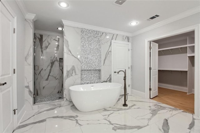 full bathroom featuring marble finish floor, crown molding, a marble finish shower, recessed lighting, and a freestanding bath