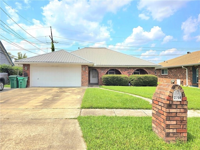 ranch-style home featuring a garage and a front yard