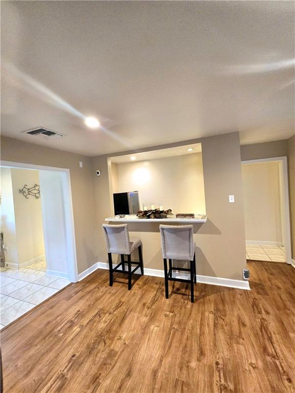 office area featuring a textured ceiling and light hardwood / wood-style flooring