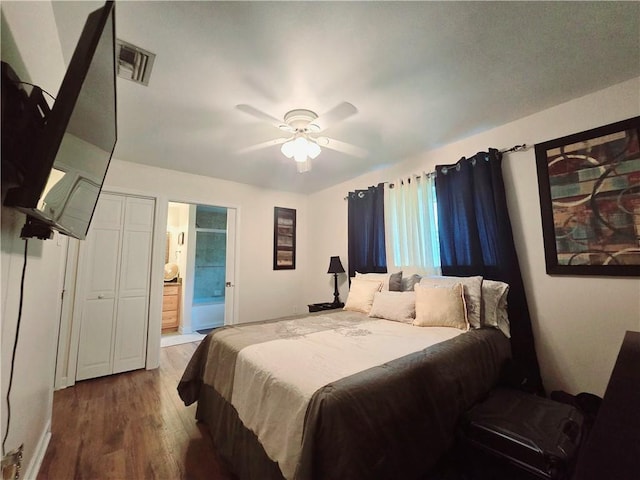 bedroom featuring ceiling fan, hardwood / wood-style flooring, and ensuite bath