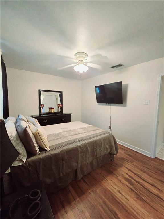 bedroom featuring ceiling fan and hardwood / wood-style flooring