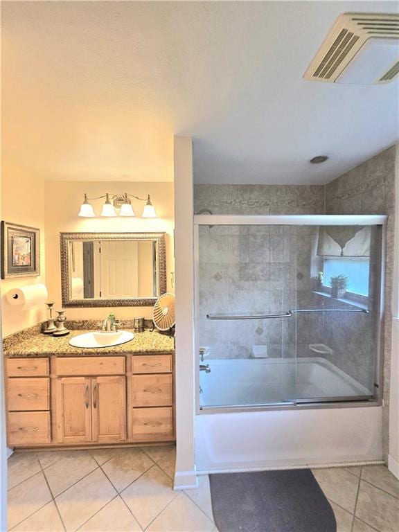 bathroom featuring combined bath / shower with glass door, vanity, and tile patterned floors